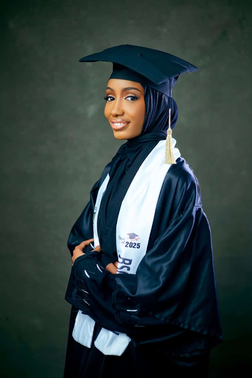 elegant graduation portrait of young woman in gown