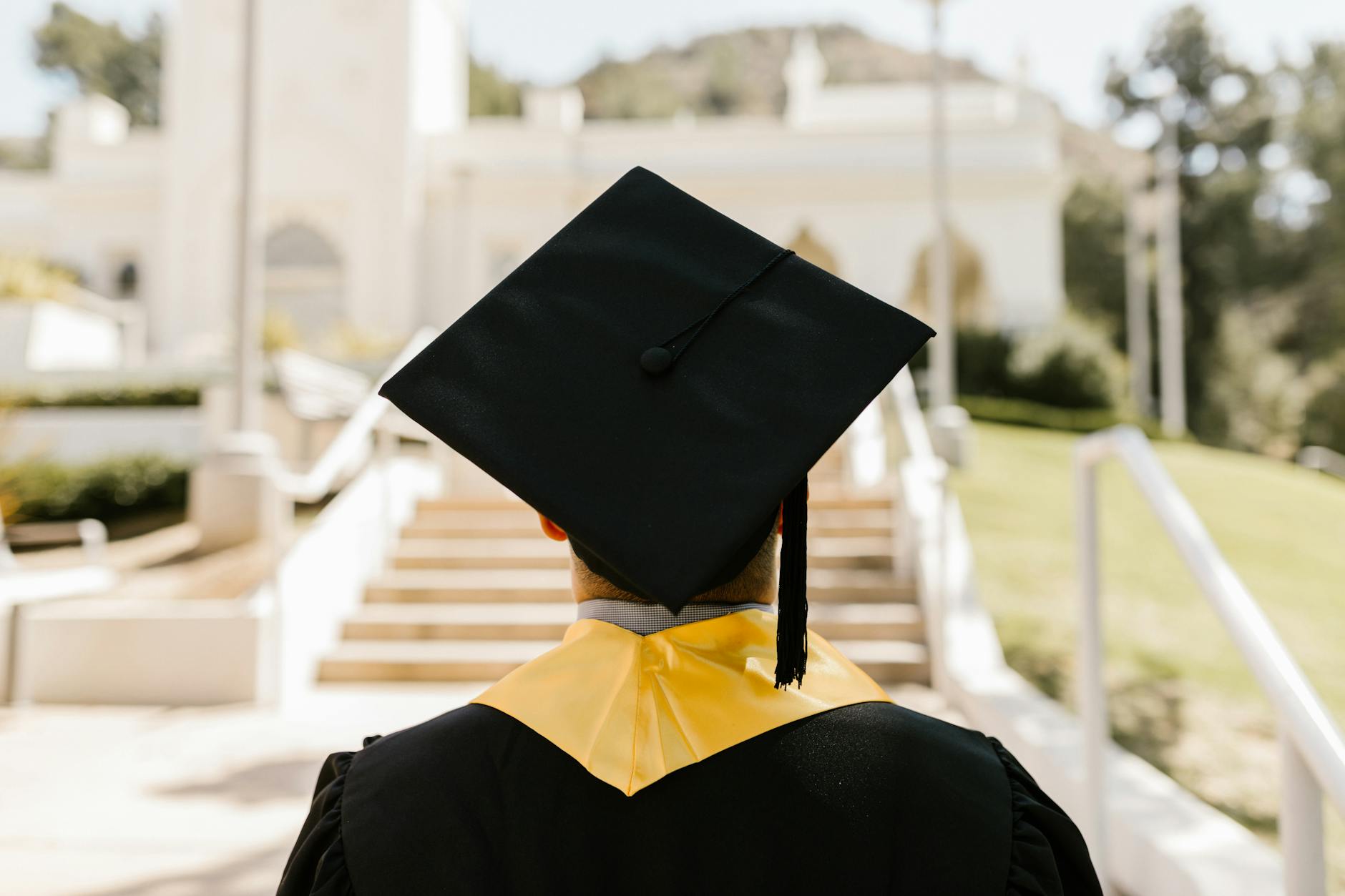 a graduate wearing a mortarboard and a graduation gown